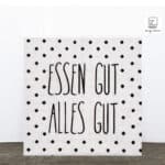 Wandbild mit Spruch "Essen gut, alles gut" und schwarzen Punkten, dekorativ und modern.