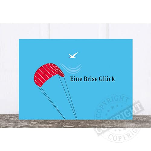 Ein kleine rote Fallschirm mit Vogel und Wasserwellen, Text: Eine Brise Glück, Glücksmoment, Luftfah.