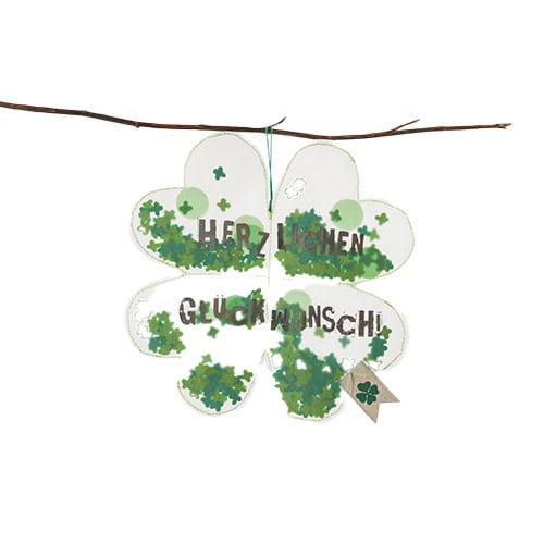 Frühling Glücksklee Glückwunsch Glücksmotiv mit vierblättrigem Kleeblatt und Grußwörtern, hängend an.
