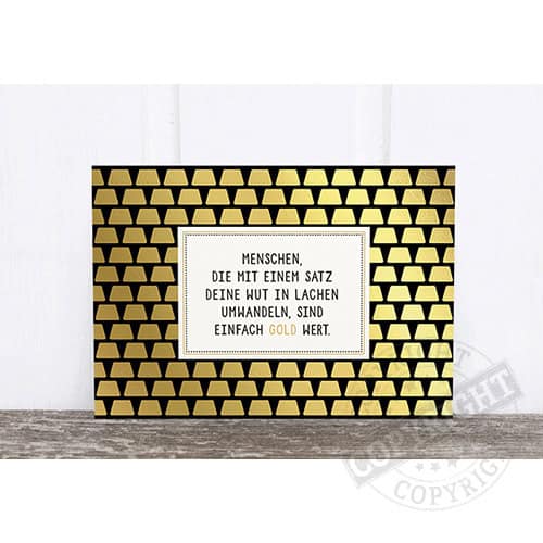 Motivtafel mit goldenen Dreiecken und inspirierendem Zitat in Deutsch.
