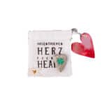Hochwertige Herz-Pochette mit kleinen Anhängern, ideal als Geschenk oder Accessoire.