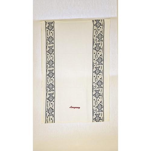 Ein weißes Handtuch mit schwarzem und gelbem Muster, aufgehängt an einer weißen Wand.